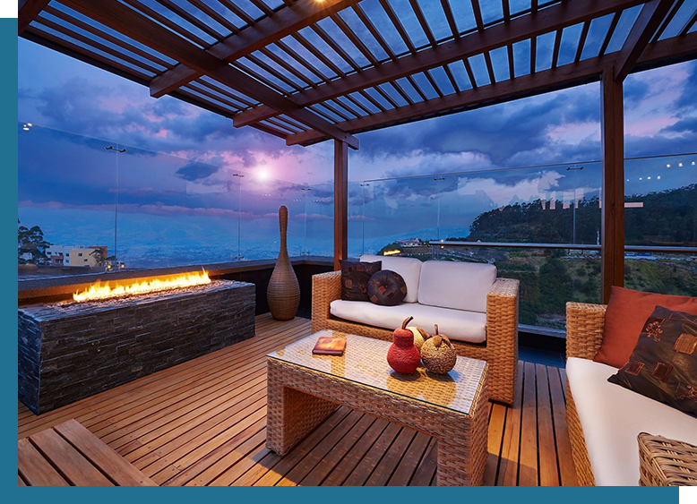 A patio with furniture and fire pit on top of it.